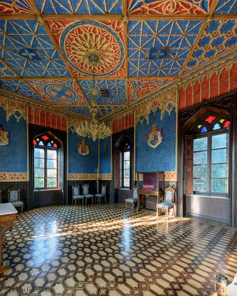 Louis XIV room with chairs and chandelier at Pyrgos Vasilissis winery